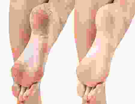 A close up of two feet with different skin tones